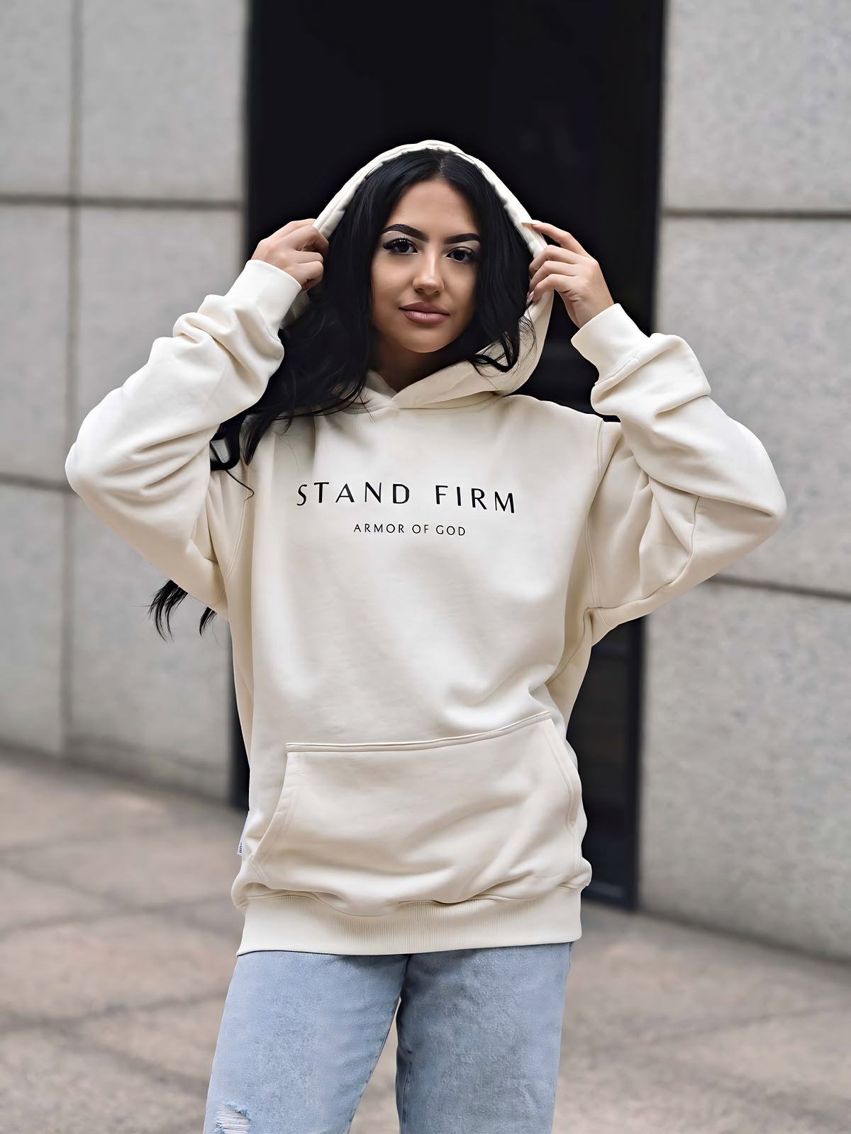 Model wearing Cream Armor of God premium heavyweight hoodie