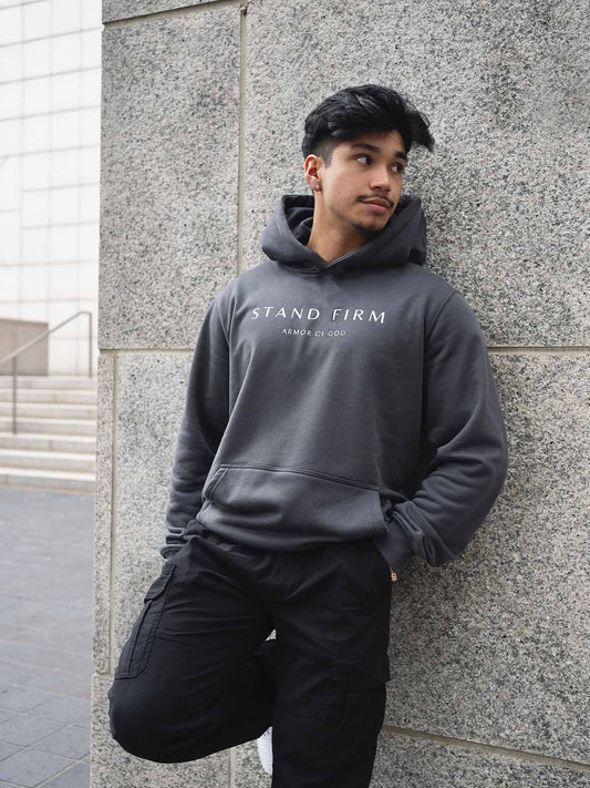 Model wearing Granite Gray Armor of God premium heavyweight hoodie
