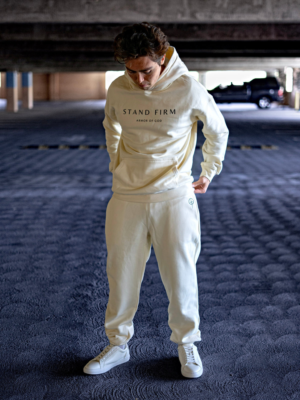 Model wearing Cream Armor of God premium heavyweight hoodie