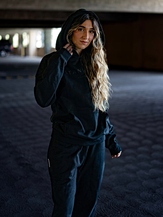 Model wearing Revelation Black Armor of God premium heavyweight hoodie