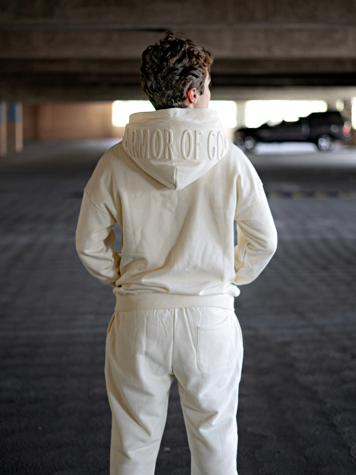 Model wearing Cream Armor of God premium heavyweight hoodie