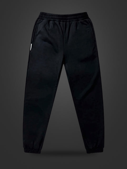 Revelation Black premium heavyweight athleisure joggers, front view on dark background