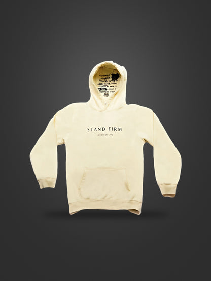 Cream premium heavyweight hoodie, front view on dark background with Stand Firm chest print and verse inside the hood