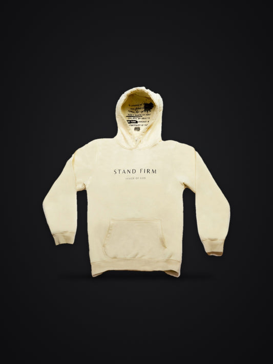 Cream premium heavyweight hoodie, front view on dark background with Stand Firm chest print and verse inside the hood