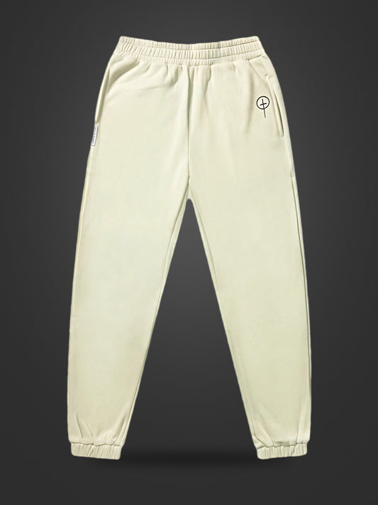 Cream premium heavyweight athleisure joggers, front view on dark background