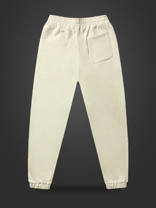 Cream premium heavyweight athleisure joggers, rear view on dark background